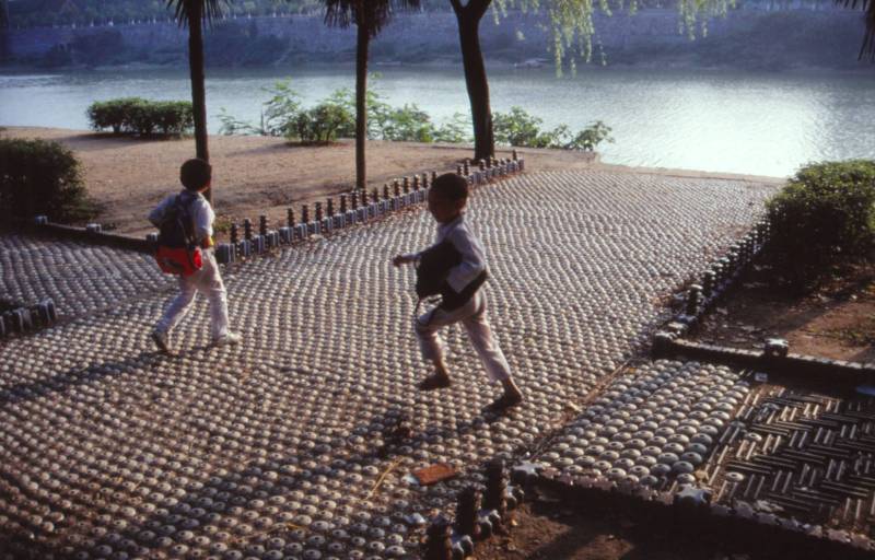 Kids playing on porcelain insulators